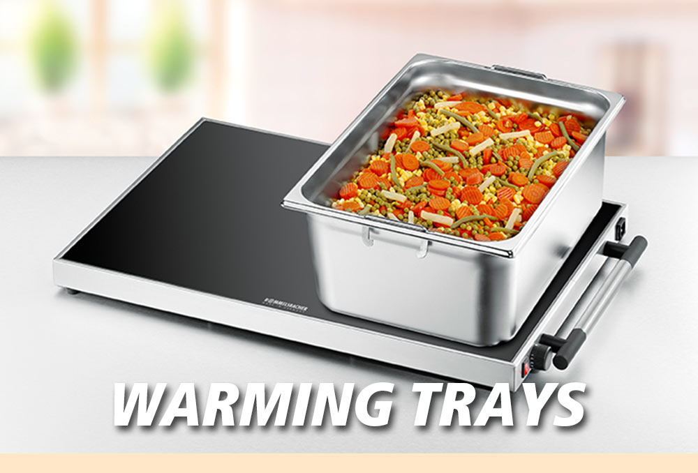 An electric warming trays with a large stainless steel container full of vegetables and pasta. The text in the image reads: “WARMING TRAYS”.