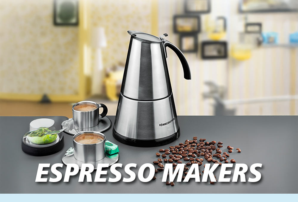 A silver espresso maker with two cups of coffee, coffee beans, and green pralines on a table. The text in the image reads: “ESPRESSO MAKERS”.