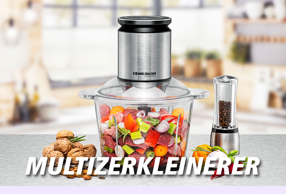 Ein Multizerkleinerer mit Glasbehälter, gefüllt mit buntem Gemüse, daneben Walnüsse, Pfeffermühle und Kräuter. Im Bild steht in weißer Schrift: „MULTIZERKLEINERER“.
