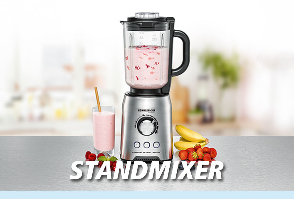 Ein Standmixer mit rosa Smoothie im Behälter und Glas, daneben liegen Bananen, Erdbeeren und Weintrauben. Im Bild steht in weißer Schrift: „STANDMIXER“.